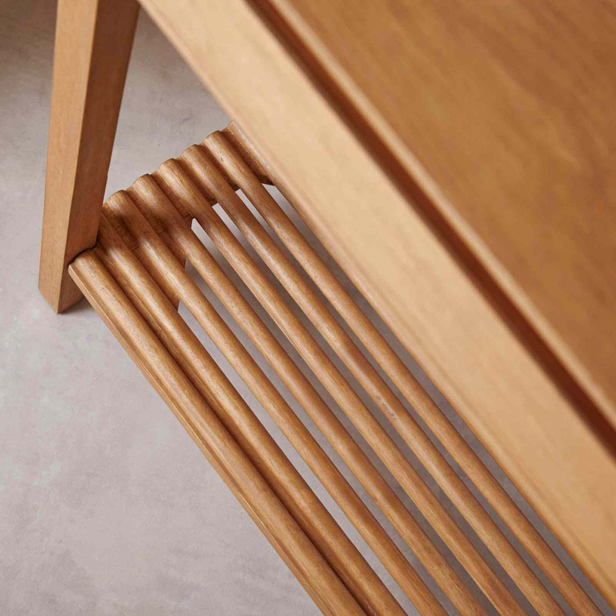 Slatted hardwood shelf detail of the Fishe & Lilly Melia Console Table with Two Drawers.