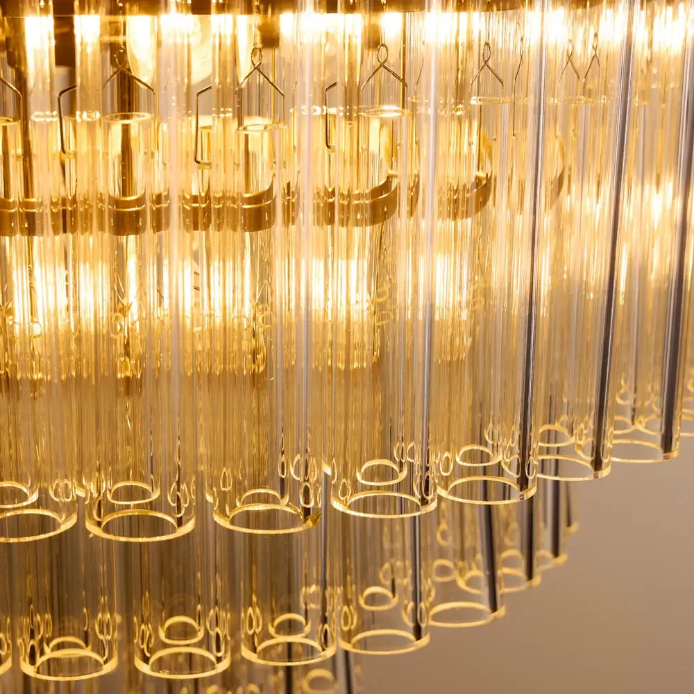 Pooky Astrid Chandelier in Clear Glass with elongated glass rods illuminated from within.