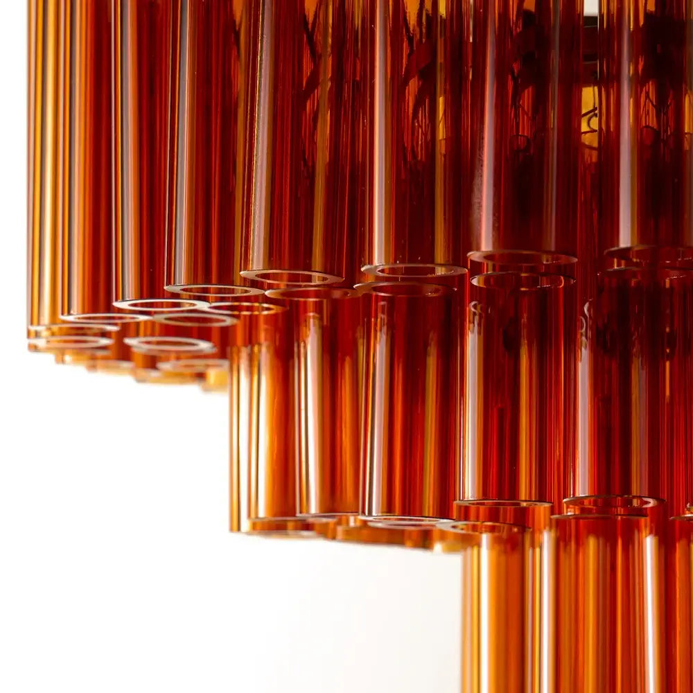 Pooky Chiara Chandelier in Amber Glass featuring amber glass tubes and warm brass fittings.