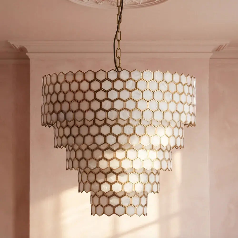 Pooky Glamazon Five Tier Chandelier in Brass and Resin showcasing hexagonal panels and warm lighting.