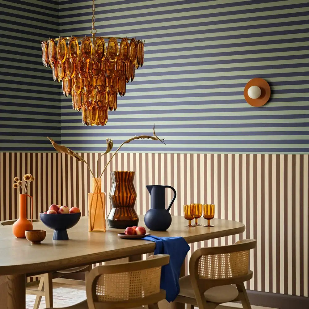SALE Pooky Lyle Chandelier in amber glass hanging above a stylish dining table with decorative vases and tableware.