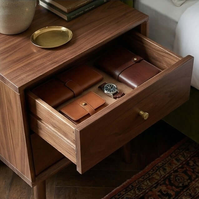 Open drawer of the Fishe & Lilly Wright Walnut Bedside Table showing interior storage and brass hardware.