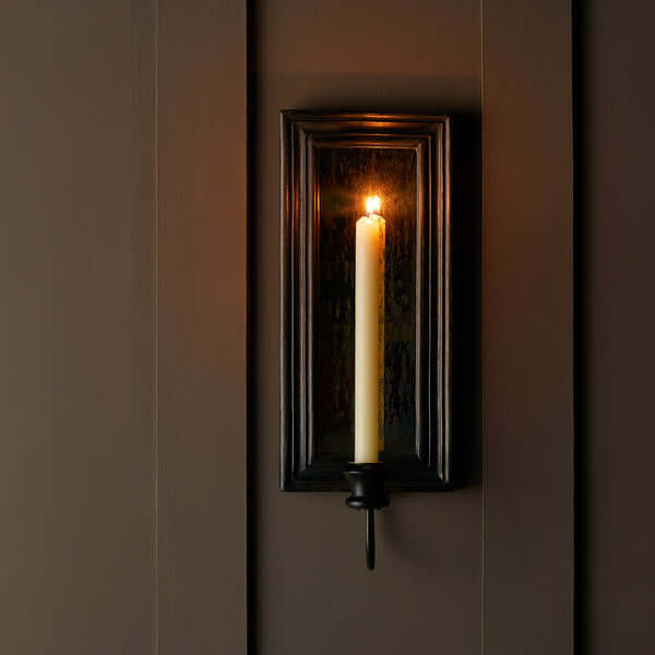 Pooky - Degas Wall Mounted Candle Holder - Ebony with candle lit, mounted on a wall, adding warmth and elegance.