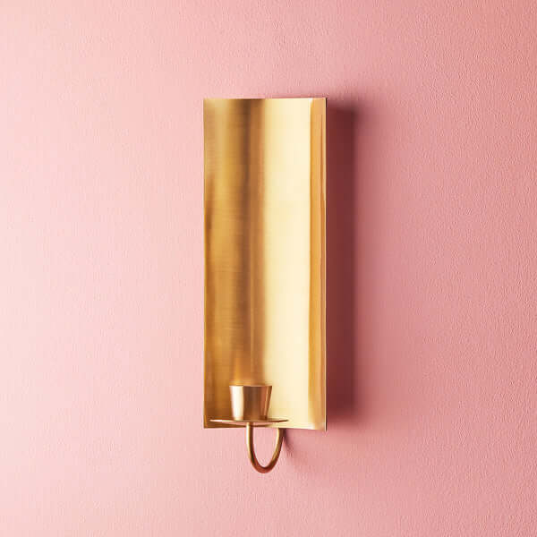 Pooky - Pitti Wall Mounted Candle Holder - Antiqued Brass on pink wall, showcasing elegant design.