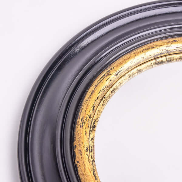 Close-up of Pooky - Audrey Mirror, featuring a black and gold ornate frame with detailed craftsmanship.