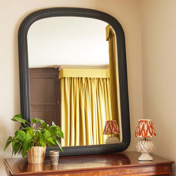 Pooky - Benedict Mirror - Ebony Wood reflecting elegant decor with green plant and stylish lamp.