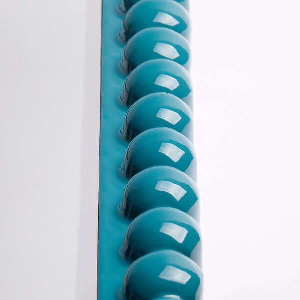 Pooky - Charming Mirror - Turquoise decorative detail with a row of glossy turquoise spheres.