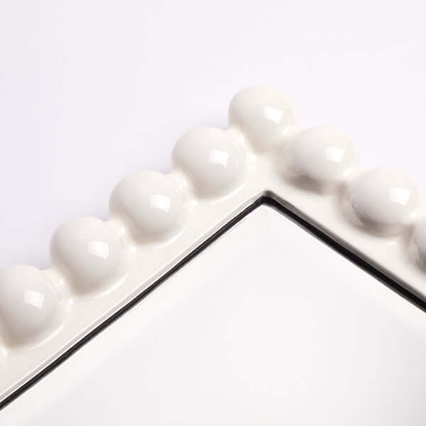 Pooky - Charming Mirror - White close-up of the white carved wooden frame design