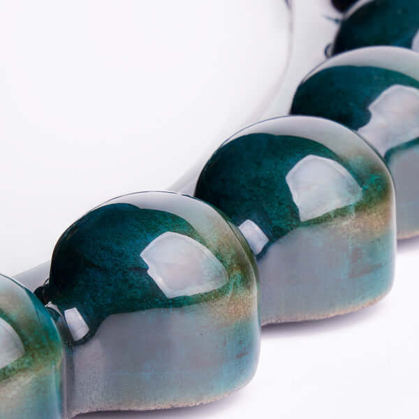 Pooky - Flynn Mirror - Teal close-up of the reflective surface and teal acrylic glaze detail.