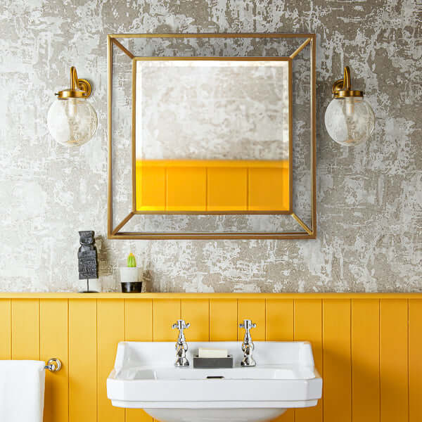 Pooky - Grenada Mirror - Antiqued Brass Finish above a yellow sink in a stylish bathroom setting.