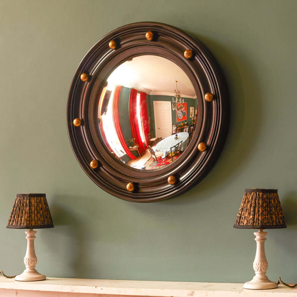 Pooky - Lauren Mirror with golden baubles on a wall, reflecting a stylish room decor.