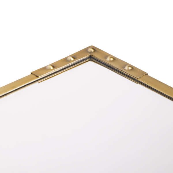 Close-up of the elegant Studland Mirror - Brass by Pooky highlighting the studded frame detail.