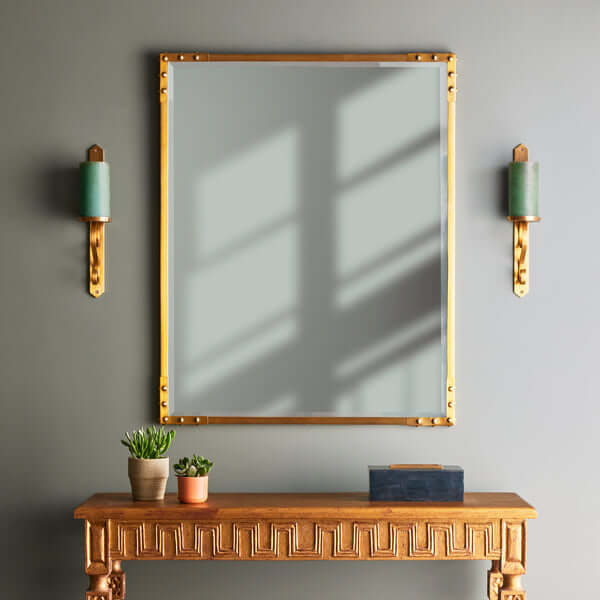 Pooky - Studland Mirror - Brass displayed above a stylish wooden console table with decorative elements.