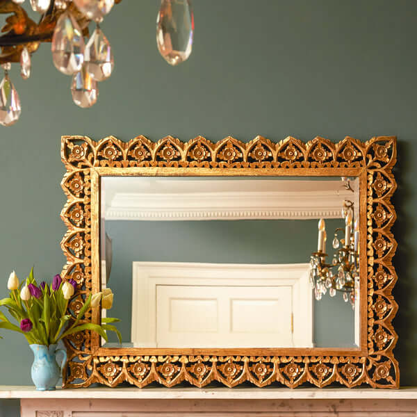 Pooky - Vulpo Bevelled Mirror - Antiqued Gold displayed above a vase with tulips.