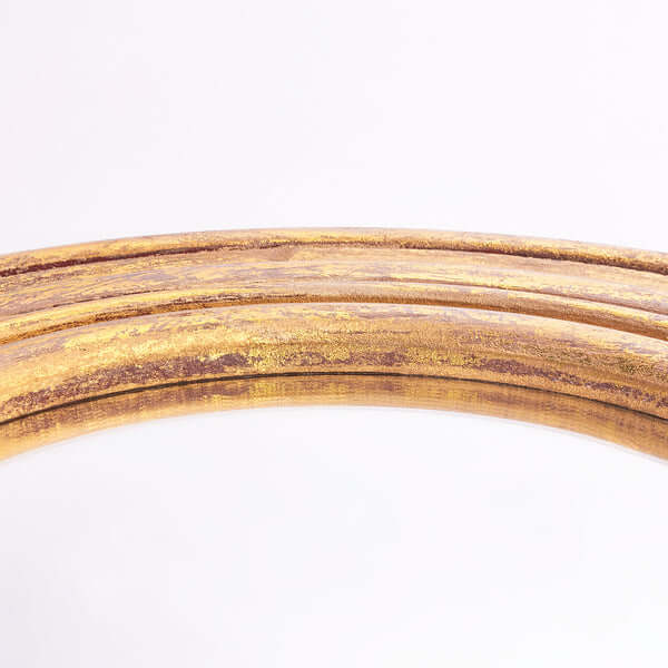 Close-up of the golden frame of the Pooky - Yves Mirror, showcasing its luxurious finish and classic design.