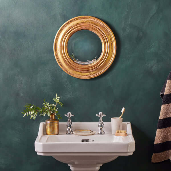 Pooky - Yves Mirror elegantly displayed above a stylish bathroom sink with green walls.