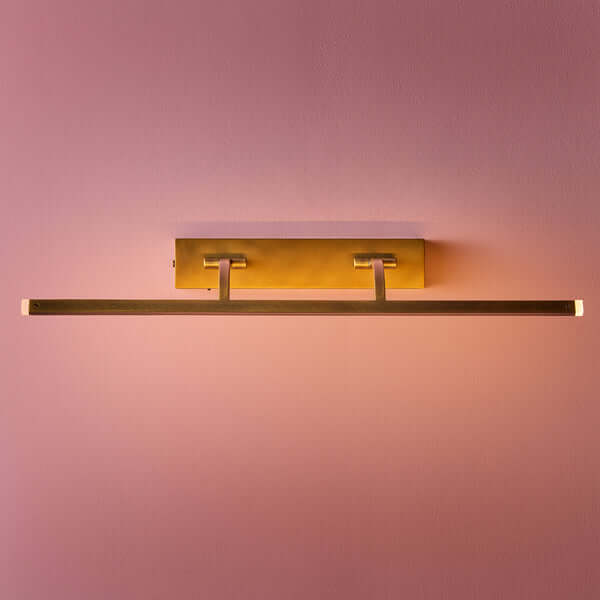 Pooky - Larger Blake Rechargeable Picture Light - Brass mounted on wall, showcasing antique brass finish and modern design.