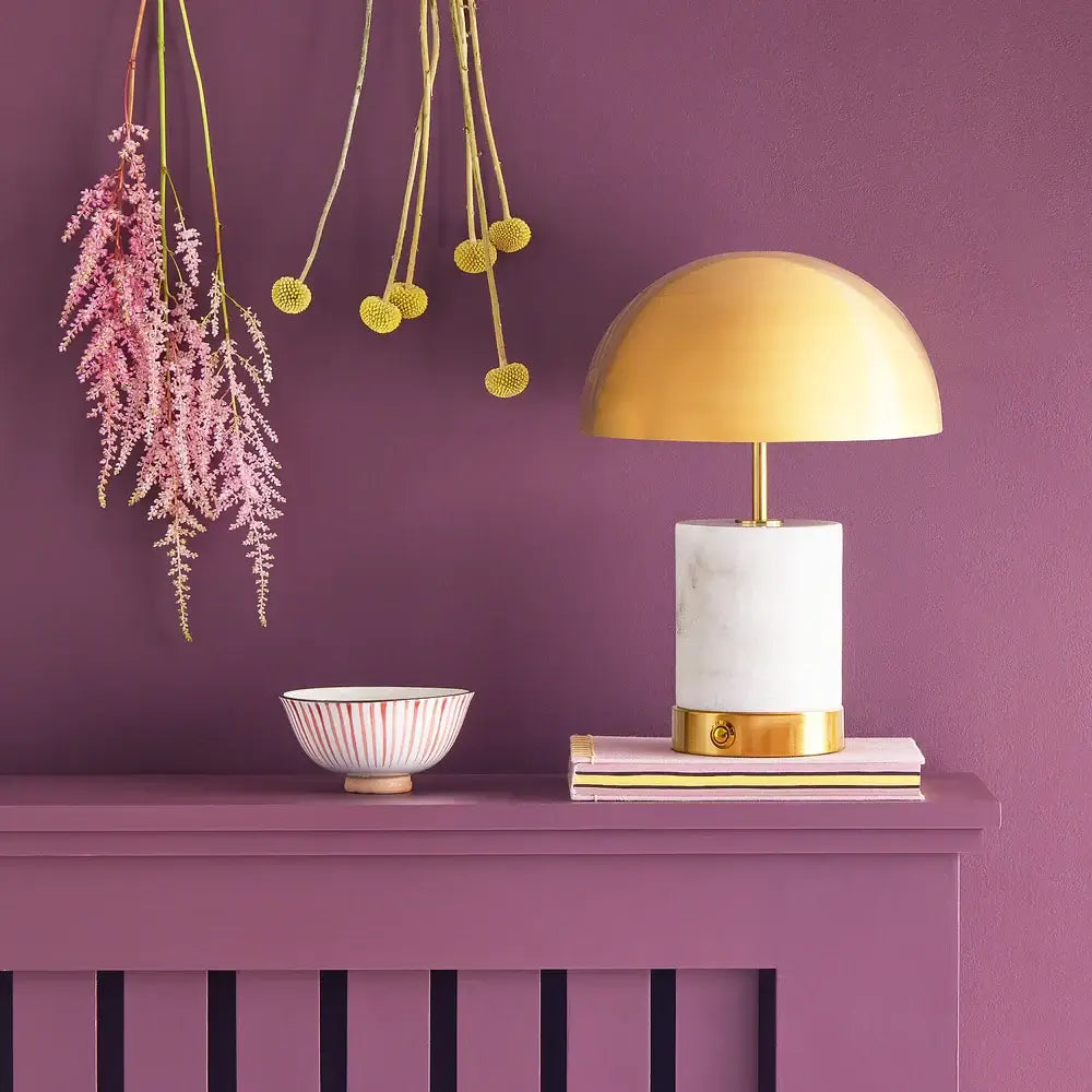 SALE - Pooky Utopia Rechargeable Table Lamp in White Marble on a purple table with decor.
