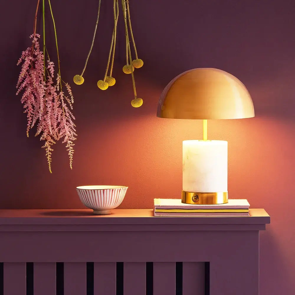SALE - Pooky Utopia Rechargeable Table Lamp in White Marble atop a stylish side table with decorative accents.