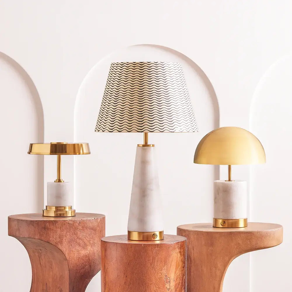SALE - Pooky Utopia Rechargeable Table Lamp in White Marble displayed with other stylish lamps.