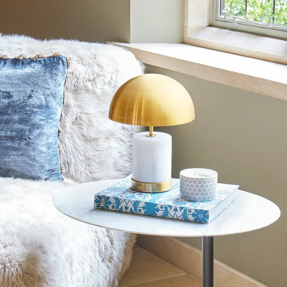 SALE - Pooky Utopia Rechargeable Table Lamp in White Marble stylishly set on a side table with decor essentials.