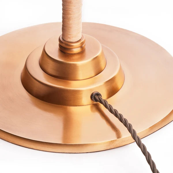 Close-up of the solid brass base of the Pooky - Abel Standing Lamp Base - Brass And Natural Rattan - Without Lampshade