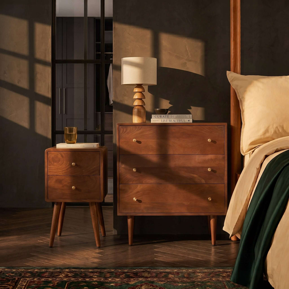 Fishe & Lilly Scandinavian Walnut Logan Narrow Bedside Table with two drawers and brass pulls in a bedroom.