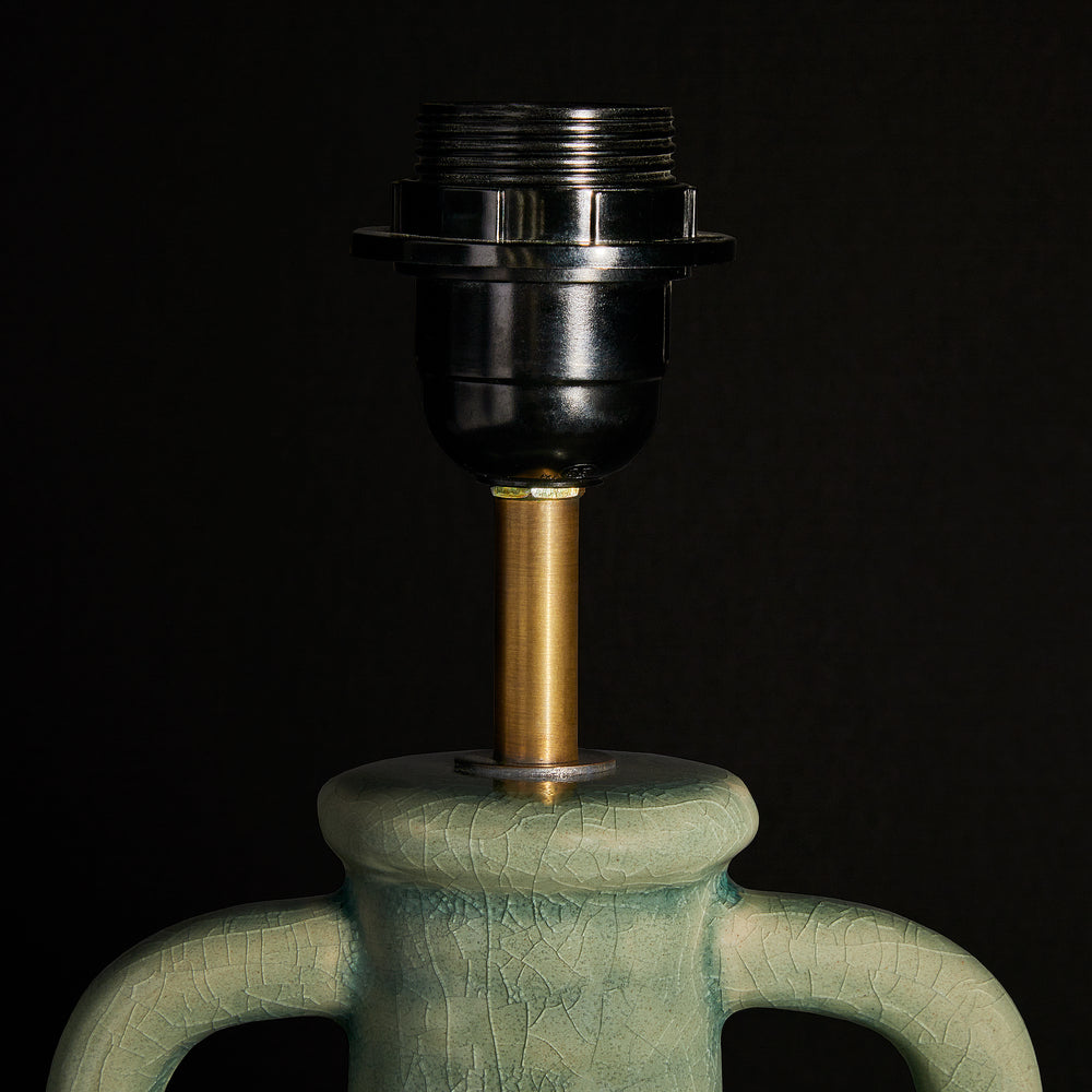 Detail of the Pooky - Ampulla Table Lamp Base - Dark Celadon featuring its antiqued crackle glaze and brass stem.