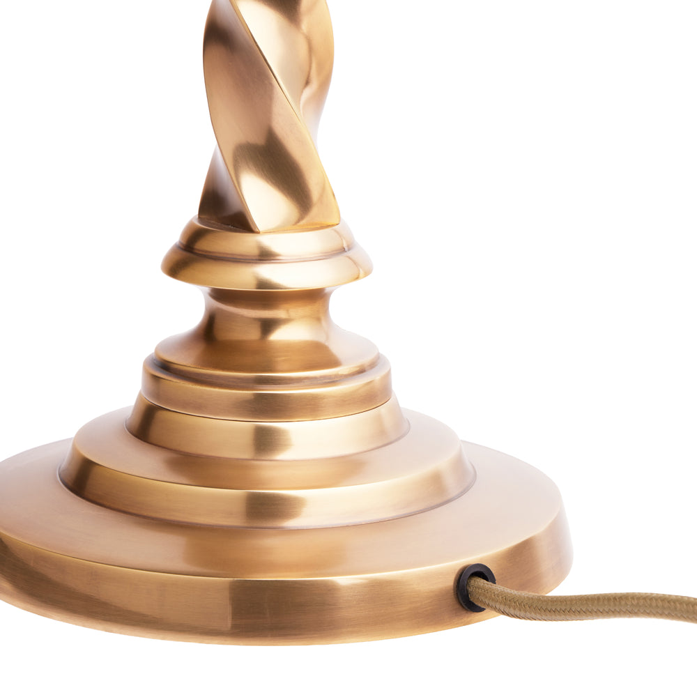Close-up of the Pooky - Cavendish Table Lamp Base - Aged Brass showing the twisted design and green flex.