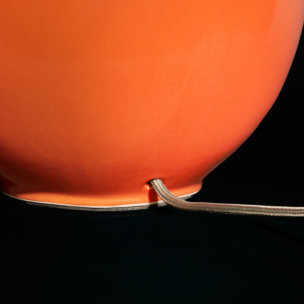Close-up detail of the flex on the Pooky - Olly Table Lamp Base - Orange.