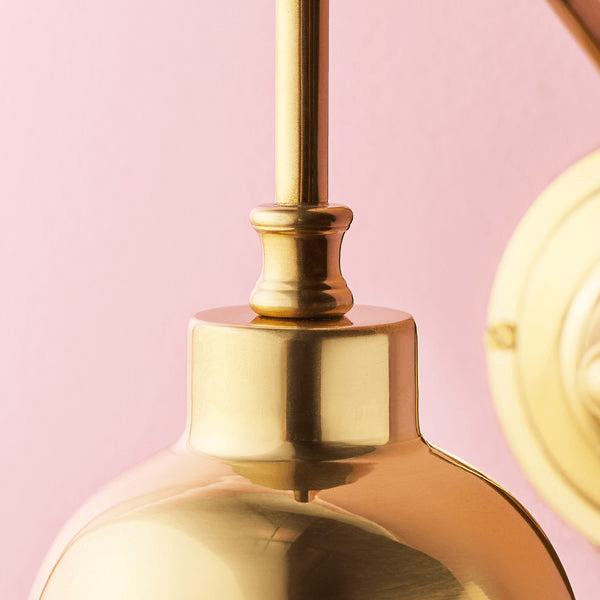 Pooky - Carmel Wall Light - Antiqued Brass Finish close-up detail of the wall arm and fixture design.