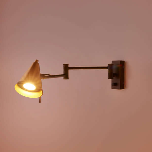 Pooky - Conrad Articulated Wall Light in Bronze with Brass Hood - Bronze and Brass mounted on a wall, perfect for reading.