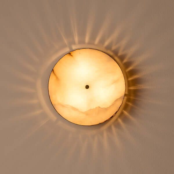 Pooky - Crenel Flush Ceiling Light - Alabaster and Brass illuminating a ceiling with soft warm light.