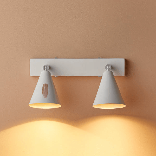Pooky - Crick Double Wall Spotlight - Paintable Finish with two cones mounted on a wall, featuring a warm glow.