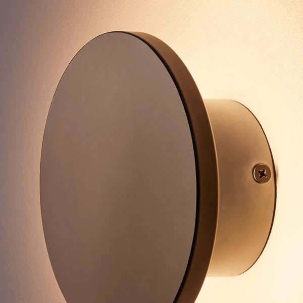 Pooky - Helios Ip44 Wall Light - Smaller - Brushed Bronze Aluminium wall sconce with soft glow, mounted on the wall.
