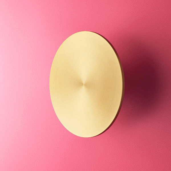 Pooky - Helios Ip44 Wall Light - Larger - Brushed Gold Aluminium mounted on a pink wall