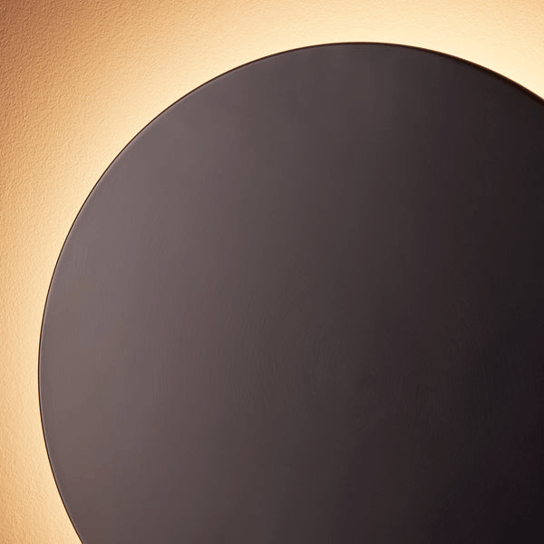 Pooky - Helios Ip44 Wall Light - Largest - Bronze Aluminium illuminating a wall with a soft glow.