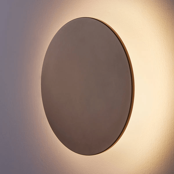 Pooky - Helios Ip44 Wall Light - Largest - Bronze Aluminium mounted on a wall, emitting a soft glow.