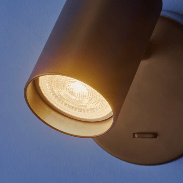 Pooky - Lewis single Wall Light - Black - With switch mounted on the wall with illuminated bulb.