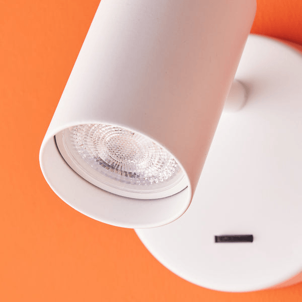 Pooky - Lewis single Wall Light - White - With switch mounted on an orange wall.