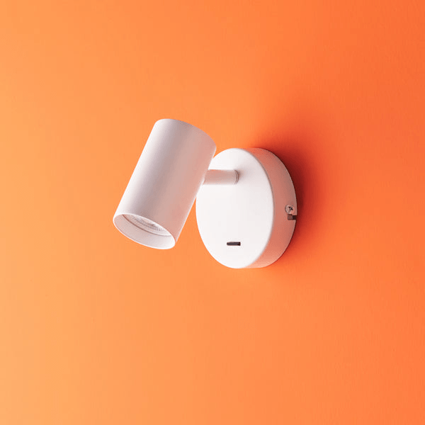 Pooky - Lewis single Wall Light - White - With switch mounted on an orange wall.