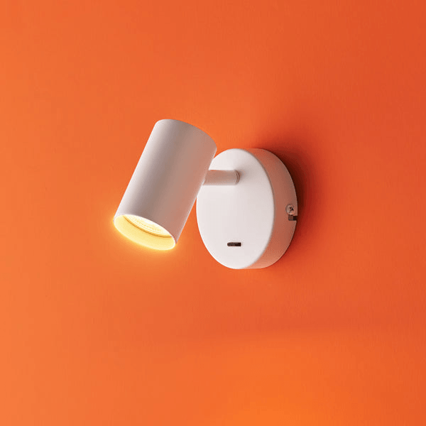 Pooky - Lewis single Wall Light - White - With switch mounted on an orange wall.