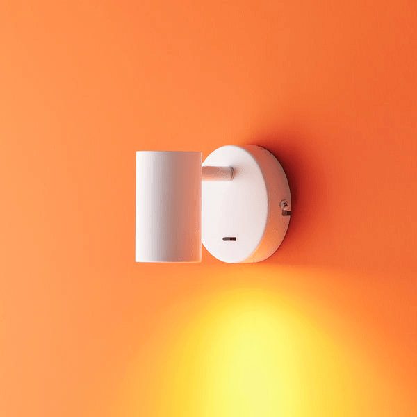 Pooky - Lewis single Wall Light - White - With switch mounted on an orange wall.