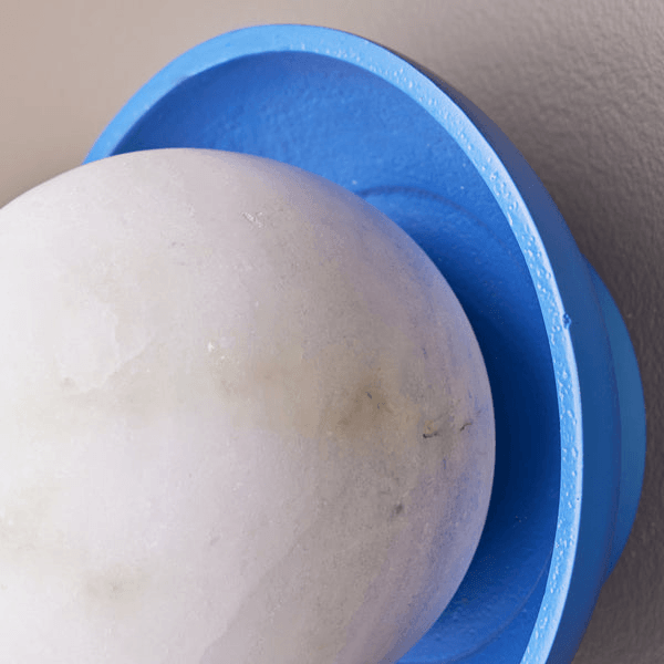 Close-up of Pooky - Luna Wall Light - Klein Blue, featuring alabaster globe and vibrant blue ceramic dish.