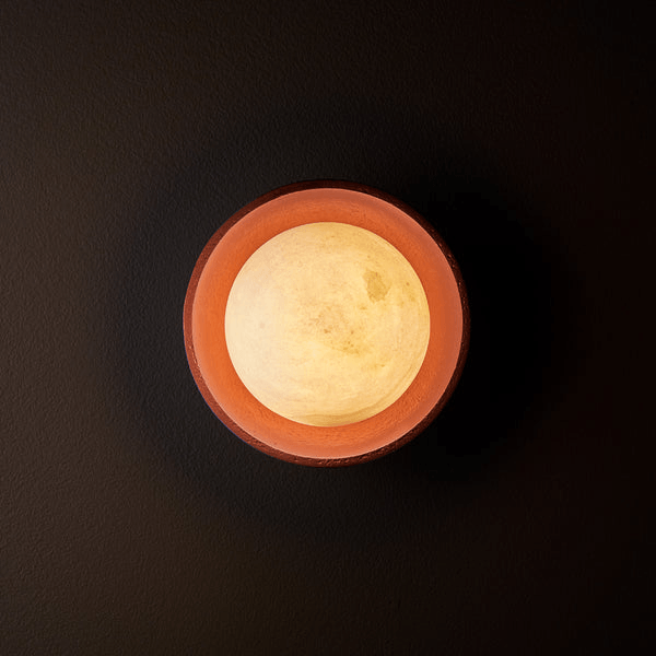 Pooky - Luna Wall Light - Terracotta Finish, top view of the lamp with a glowing alabaster globe.