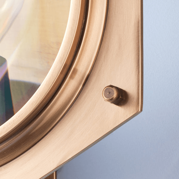 Close-up of the Pooky - Poirot Wall Light - Brass And Glass showcasing the brass frame and magnifying glass detail.