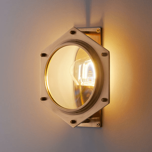 Pooky - Poirot Wall Light - Brass And Glass featuring a large magnifying glass in a hexagonal design.