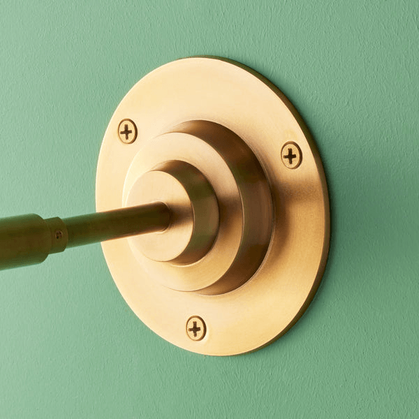 Pooky - Quantum Single Wall Light - Antiqued Brass wall mount detail on green background