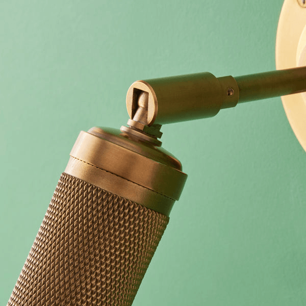 Pooky - Quantum Single Wall Light - Antiqued Brass showcasing the knurled detailing on the spotlight.