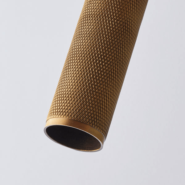 Pooky - Quantum Double Wall Light - Antiqued Brass knurled detail showcasing etching design on a decorative light fixture